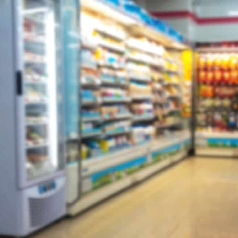 Inventory management in retail store with refrigerated section and organized product shelving.