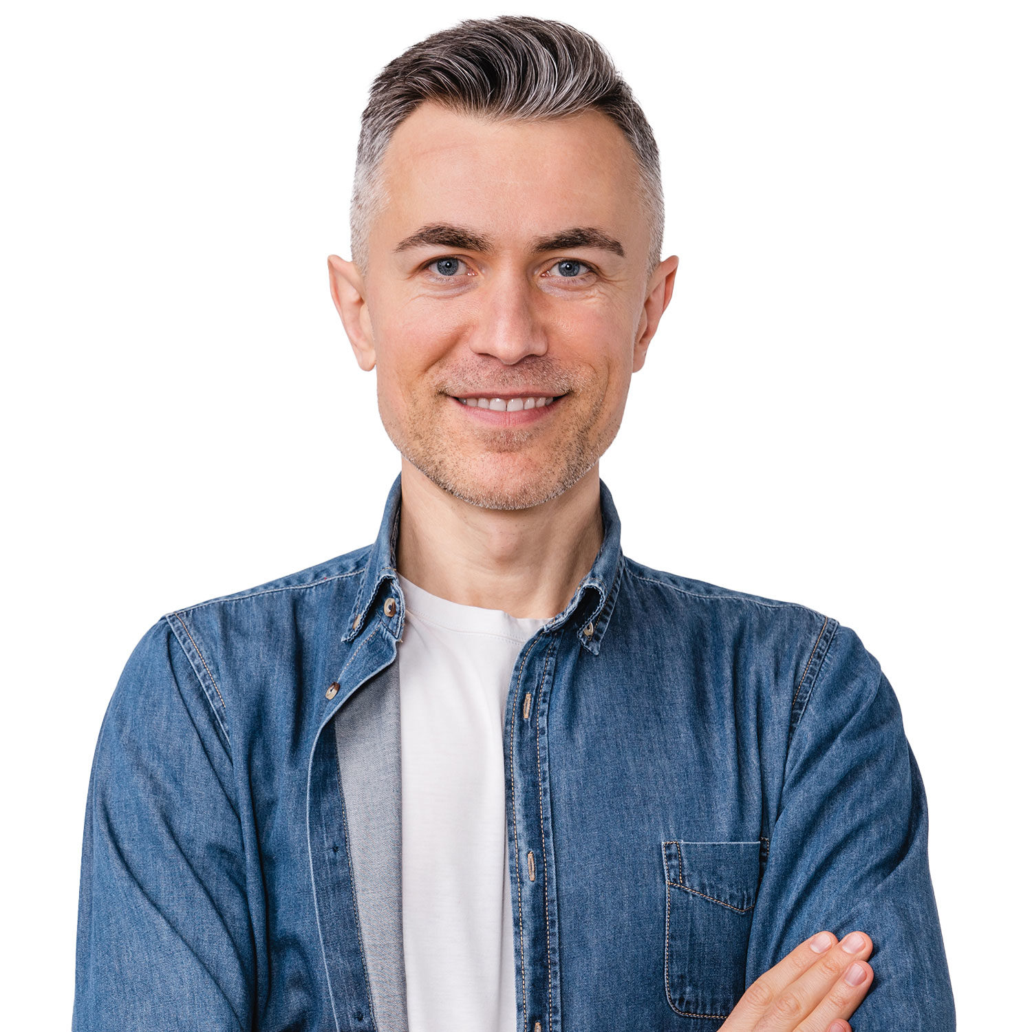 Friendly middle-aged man with short gray hair and blue eyes, smiling confidently with arms crossed, wearing a casual denim jacket and white T-shirt, against a plain white background.