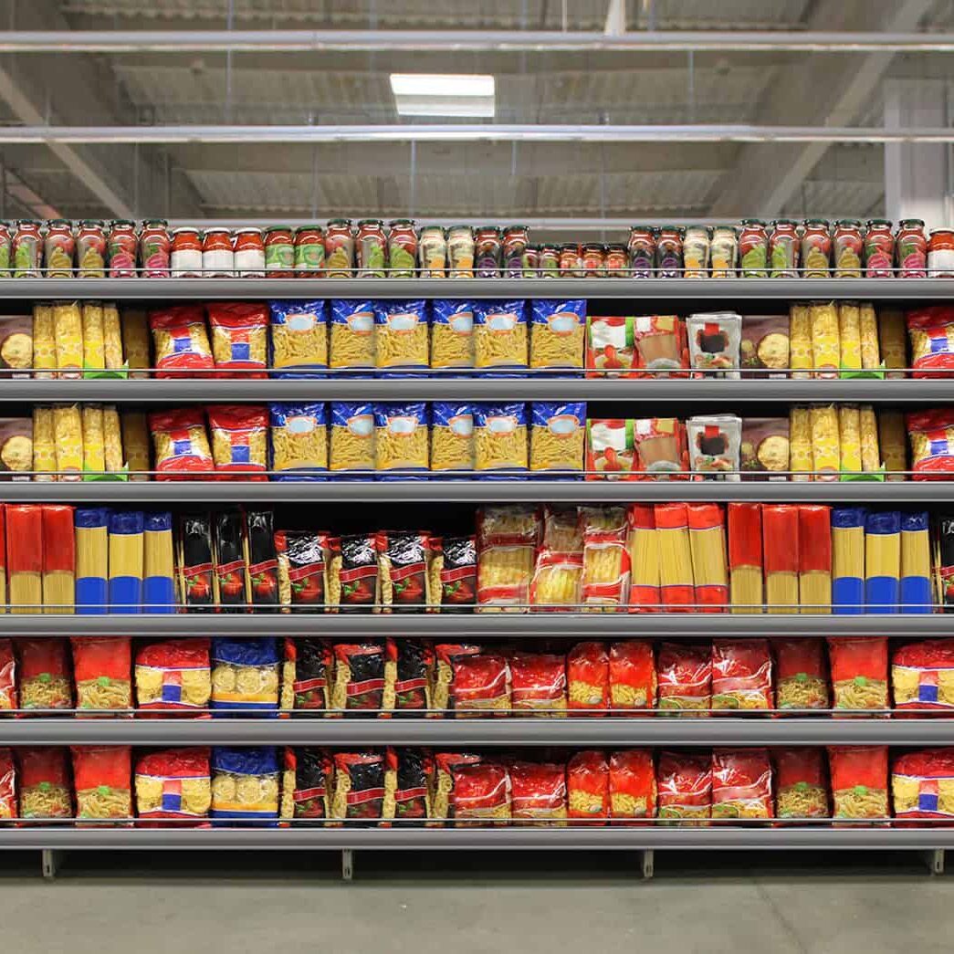 Fresh pasta and sauce products neatly arranged on store shelves in a grocery store aisle, ready for inventory management by professional inventory specialists.