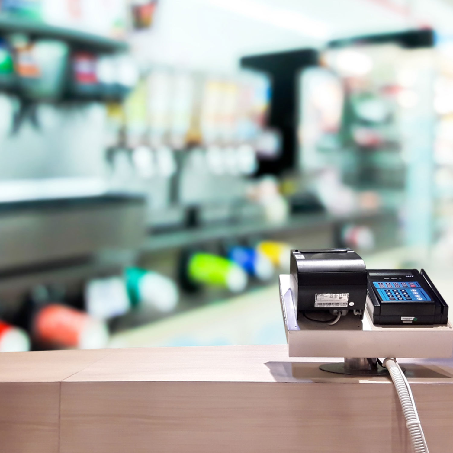 Barcode scanner and register on checkout counter at pharmacy or retail store in a well-lit environment.