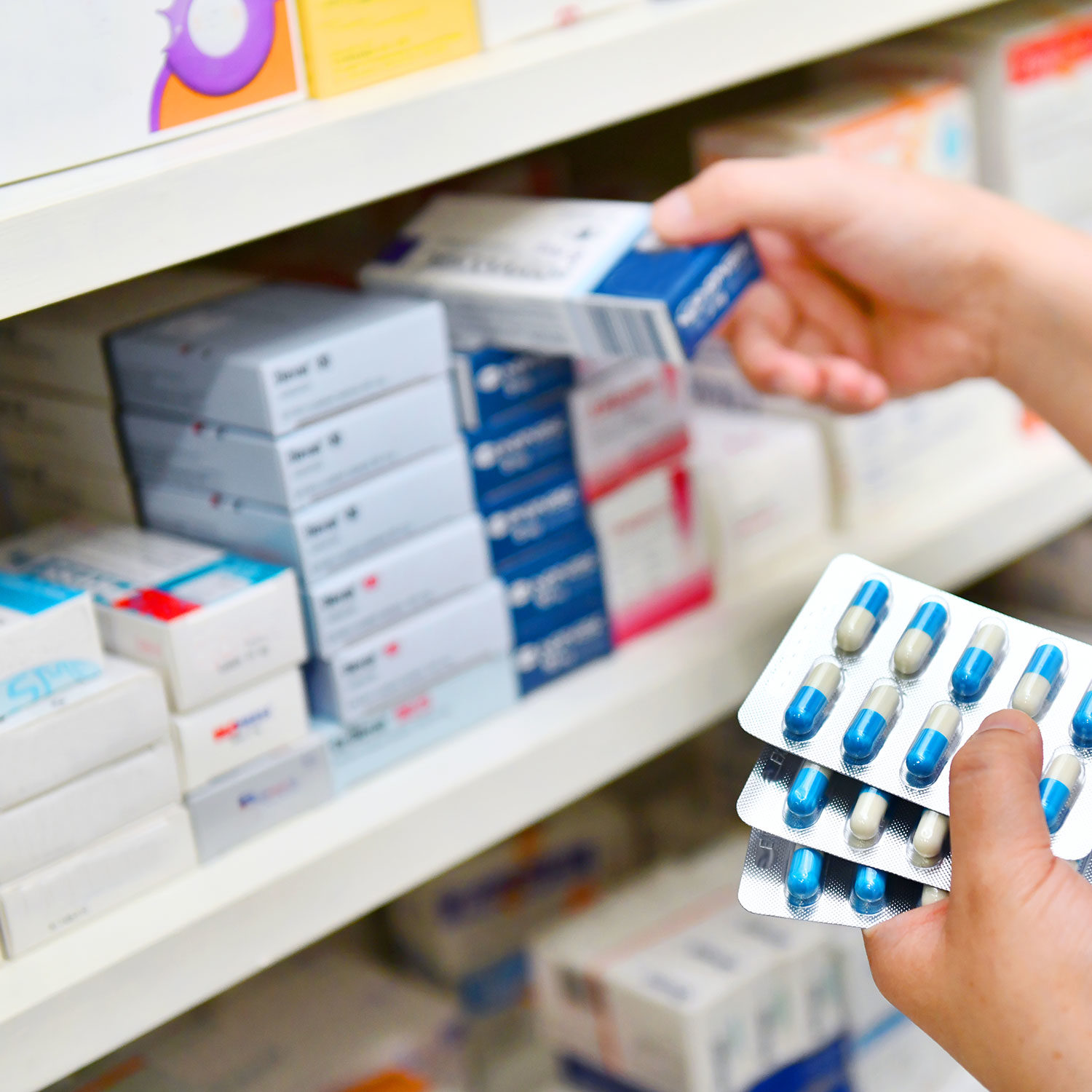 Medications and prescription drugs in blister packs and packaging on store shelves, representing inventory management and pharmaceutical product inventory.