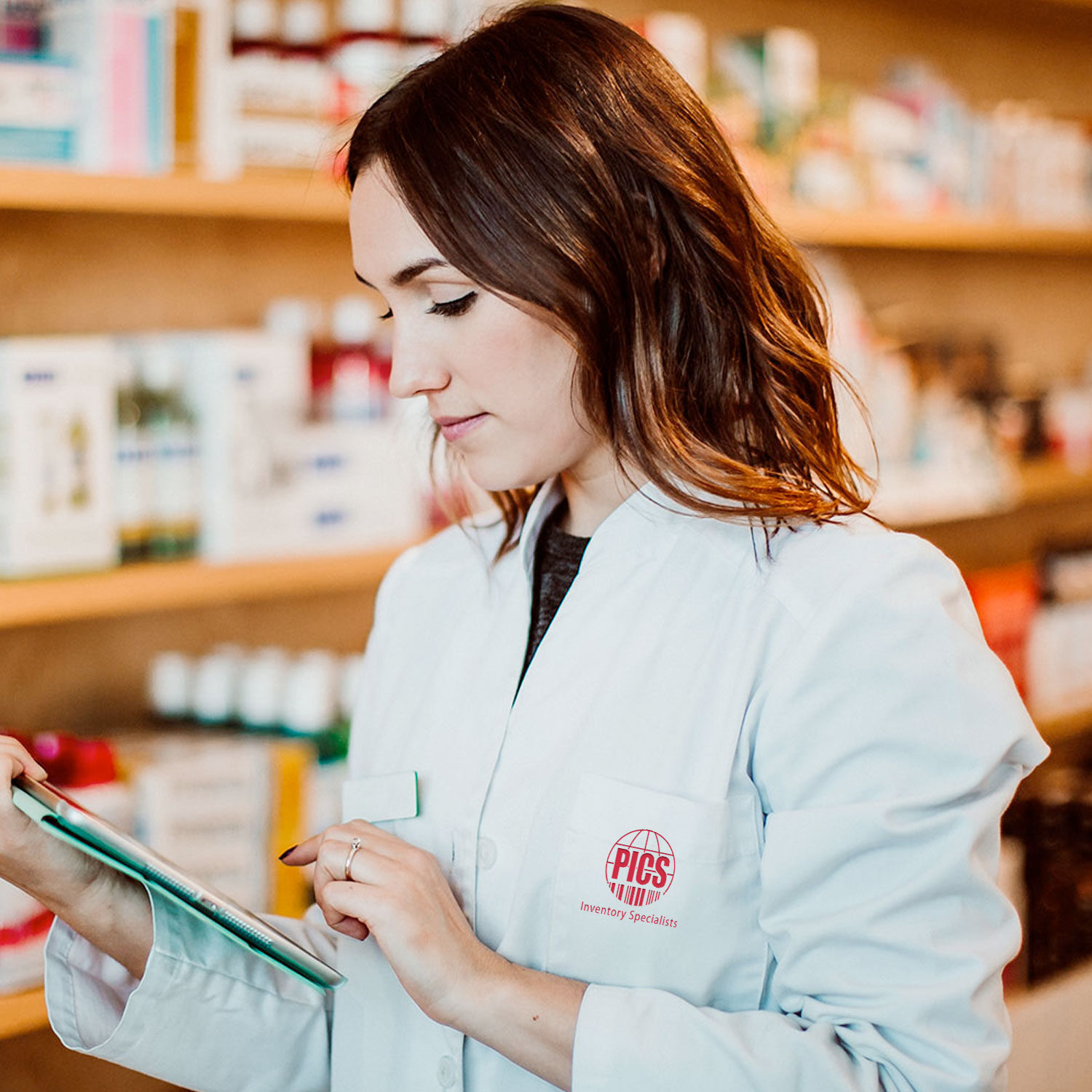 Barcode scanning pharmacy inventory management professional woman with tablet at pharmacy store.