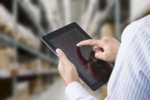 Inventory management with tablet at warehouse PICS | Inventory Specialists providing efficient inventory control and tracking solutions for businesses.