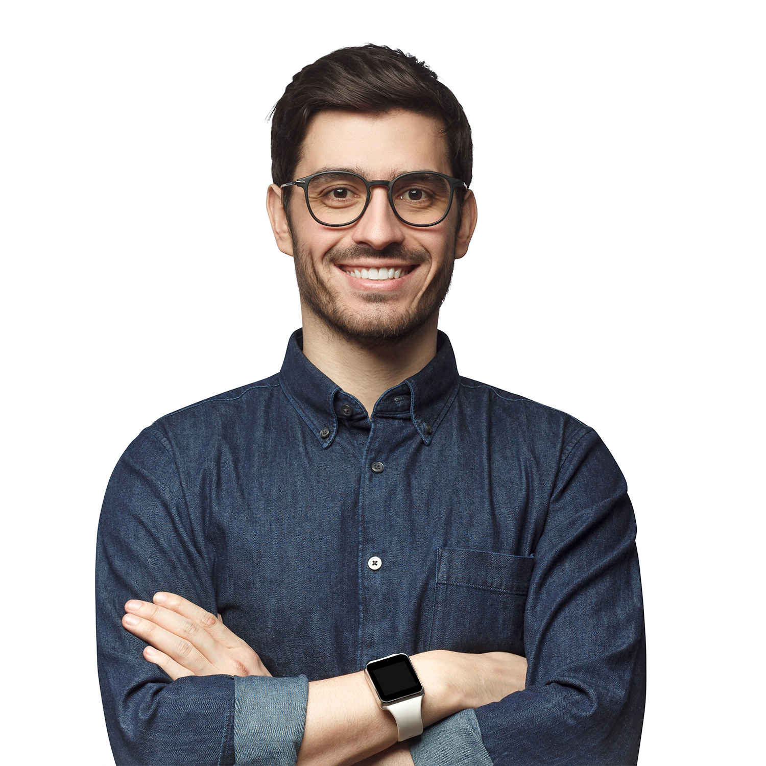 Man smiling with crossed arms wearing glasses and a denim shirt on a white background.